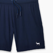 Navy Blue pocket lounge short with goat embroidery on bottom right of leg.