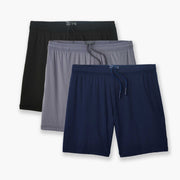 Black, grey & navy blue lounge shorts laid flay on light grey background.