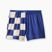 Shot of half checkered half solid navy and white lounge shorts laid flat on grey background.