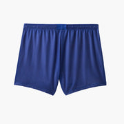 Back shot of half checkered half solid blue and white mesh lounge shorts sitting on grey background.
