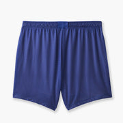 Back shot of half checkered half solid blue and white mesh lounge shorts sitting flat on grey background.