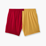 Close up shot of multi colored mesh "fun short" on a light grey background. Back colors are Yellow and Red.