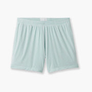 Pair of white mesh lounge short with light green interior laid flat on grey background.