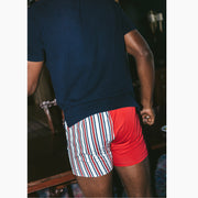 Back shot of man wearing blue shirt and red/white/blue Regatta slim fit boxer.