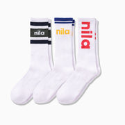 3 pairs of white crew socks in various stripe colors all with "nila" printed on. The socks are laid against a light grey background. 