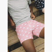 Close up shot of man wearing pink slim fit boxers with white dots.