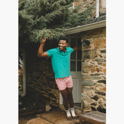 Front shot of man standing in doorway wearing green dress shirt and pink slim fit boxers with white dots