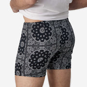 Close up back view of man wearing black bandana slim fit boxer and white t-shirt.