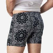 Close up back view of man wearing black bandana slim fit boxers & white t-shirt.