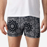 Close up front view of man wearing black bandana slim fit boxers & white t-shirt.