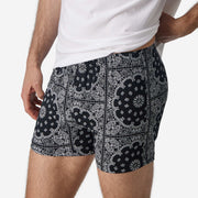Close up side view of man wearing black bandana slim fit boxers & white t-shirt.