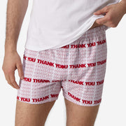 Close up front view of man wearing red & white printed "thank you" slim fit boxers & white t-shirt.
