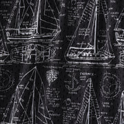 Close up detail shot of "Schooner" mesh lounge shorts that are black with white illustrations of boats.